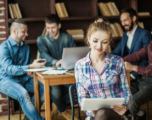 assistant young woman with laptop on the background of business 