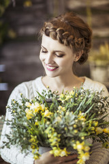 Naklejka premium portrait of a beautiful happy young woman with a bouquet of flowers