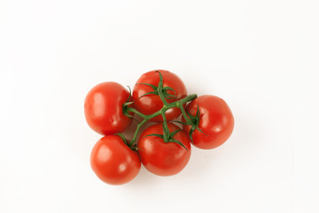 ripe tomatoes on a branch .isolated white background.