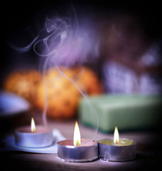 Christmas mug and candle on wooden background