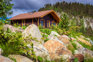 House in the mountains. Cottage. A red brown house. Buy a house in the country. Cottages for sale.