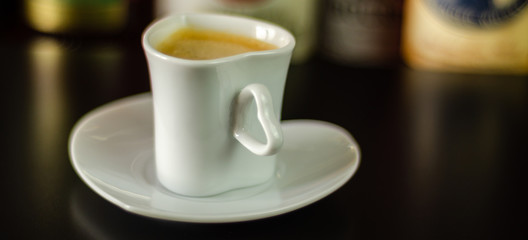 black coffee in a ceramic cup on the bar, energy drink in a public place