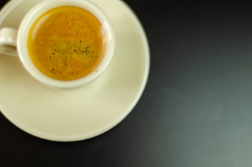 black coffee in a ceramic cup on the bar, energy drink in a public place