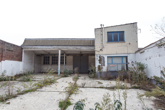 Abandoned Building With Overgrown Weeds