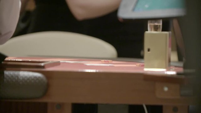 Slow motion shot of cards and chips on velvet poker table in casino. Gambling, luck and addiction concept.