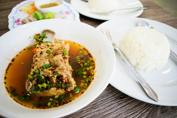 Sour pork spare rib soup, Spicy spare pork backbone, Hot and spicy pork backbone hot pot or Leng hot pot. Steamed pork with dipping sauce and cooked rice. Thai food.