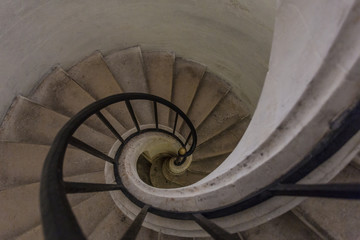 Fototapeta premium Spiral stairway leading down in a classic building