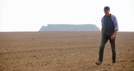 Tired Farmer Stretching While Walking In Farm - Powered by Adobe
