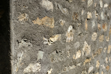 Old stone wall with cemented elements