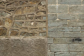 Old stone wall with cemented elements