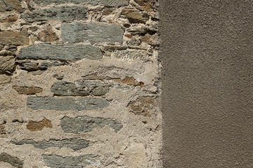 Old stone wall with cemented elements