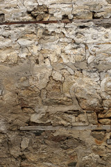 Old rock wall covered with plaster in the traditional way