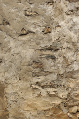 Old rock wall covered with plaster in the traditional way