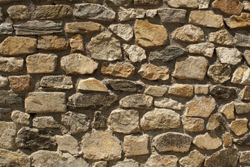 Old stone wall with cemented elements