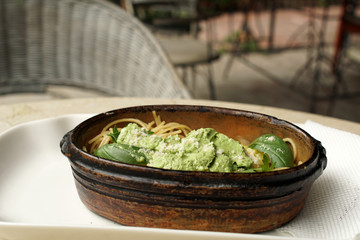 Spaghetti with spinach pasta sauce, restaurant atmosphere
