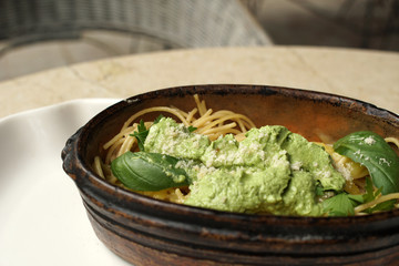 Spaghetti with spinach pasta sauce, restaurant atmosphere