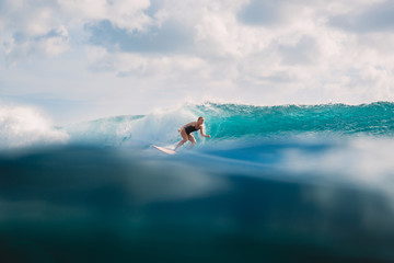 Fototapeta na wymiar Surf girl on surfboard. Woman in ocean during surfing.