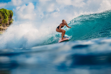 Surfer girl on wave in ocean - obrazy, fototapety, plakaty