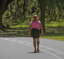 unknown woman rehabilitates a knee injury at the park