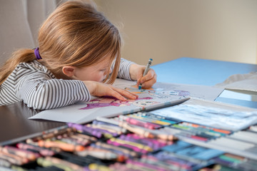 girl leaning on table to draw