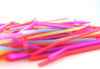 Banning plastic straws enviromental concerns concept, many straws on white background selective...