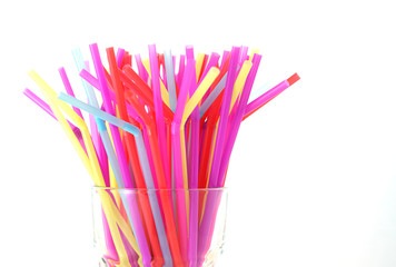 Banning plastic straws enviromental concerns concept, many straws against white background.