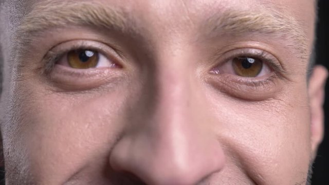 Eyes of blond man hipster is watching at camera, smiling
