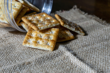 Biscuits on wooden background with selective focus and crop fragment