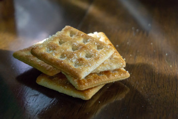Biscuits on wooden background with selective focus and crop fragment