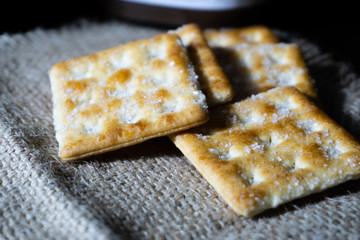 Biscuits on wooden background with selective focus and crop fragment