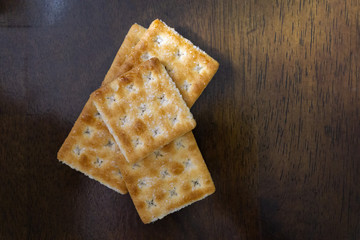 Biscuits on wooden background with selective focus and crop fragment