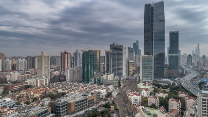 Fototapeta premium Aerial view of highway and buildings in West Yan`an road, Shanghai city on a cloudy day