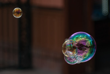 multicolored cluster of bubbles with reflections floating with a dark background
