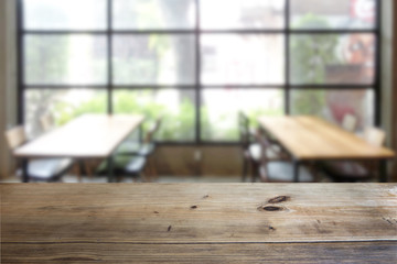 Empty real wooden deck table over over the coffee shop, restaurant, co-working space background. for mock up concept