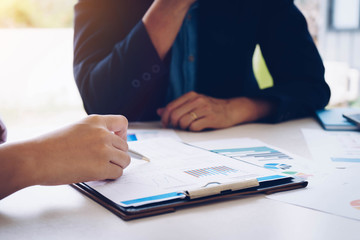 Business people meeting to analyze and discuss the situation on the financial report in meeting room. Meeting planning budget and cost. Business financial analysis and strategy concept.