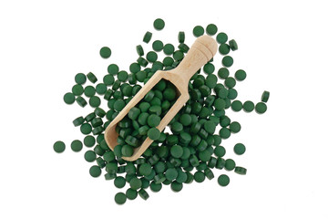 Algae spirulina tablets in a scoop isolated on a white background. Super food concept. Food supplements for a healthy lifestyle