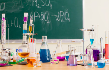 Glass flasks with multi-colored liquids at the chemistry lesson