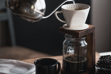 coffee In a glass bottle,Coffee drip,Hand holding a kettle Drip Coffee In the room