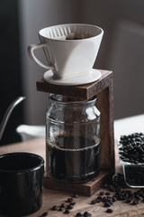 coffee In a glass bottle,Coffee drip,Hand holding a kettle Drip Coffee In the room