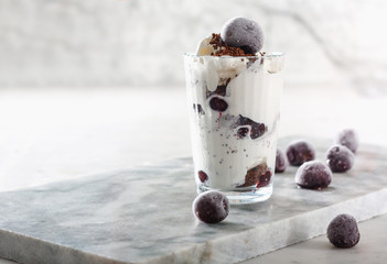 Ice cream with cherry berries on  marble countertop background