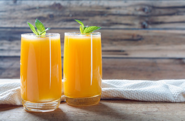 Healthy pumpkin fruit smoothie with  mint leaves on  table.