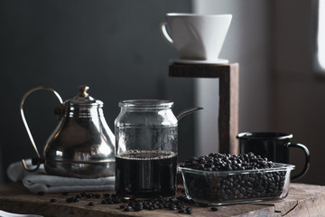 coffee In a glass bottle,Coffee drip,Hand holding a kettle Drip Coffee In the room