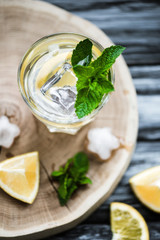 top view of cold fresh summer drink with mint and ice cubes in glass