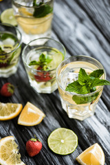 close-up view of fresh cold summer cocktails in glasses on wooden table