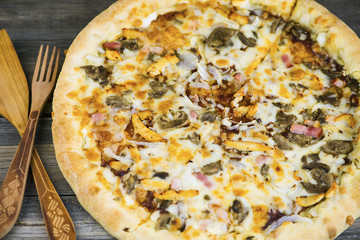 round carbonara pizza with Mozzarella cheese on an old wooden table