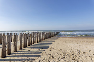 The Timber Piles throw their shadow on the  Beach at Domburg/ Netherlands