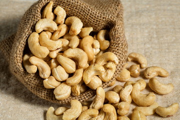 Cashew nuts in sackcloth pouch on the desk.