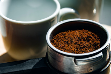 Ground coffee in portafilter, closeup