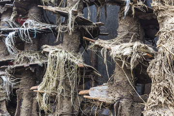 Agricultural machinery on a farm.The mechanism on the trailer-distributor of fertilizers from cow manure and straw. After work in the field.Close-up .