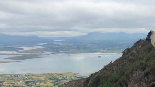 View from Croagh Patrick mountain in Co. Mayo, Westport, West coast of Ireland, Atlantic ocean. Amazing scenic sea and mountain landscape with islands in cloudy day.